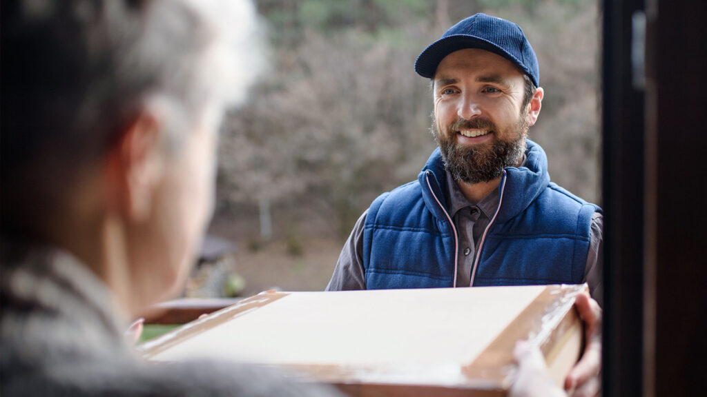 man in a blue vest deliverying medications