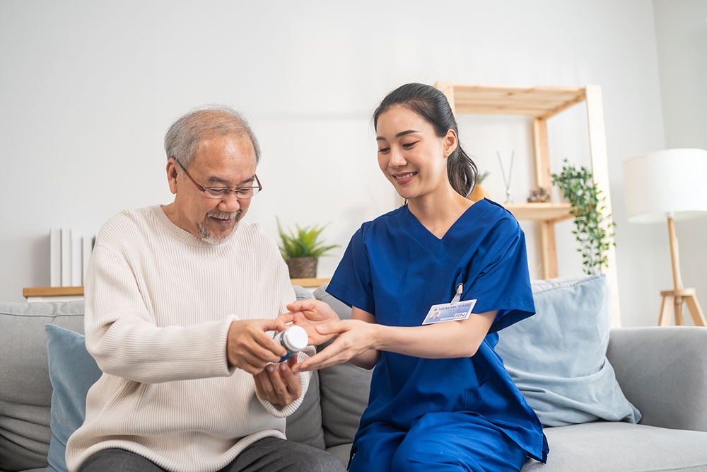 nurse educating senior man about his medication