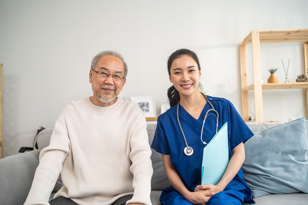 nurse and senior man posing for a photo